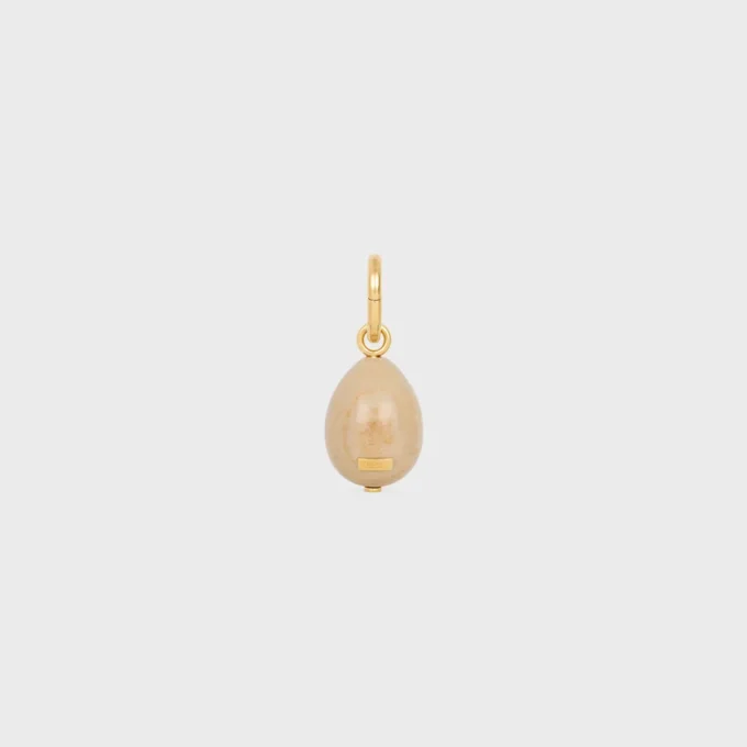 Anhänger „Stone Egg“ aus Botticino und Messing mit Goldfinish Anhänger „Stone Egg“ aus Botticino und Messing mit Goldfinish