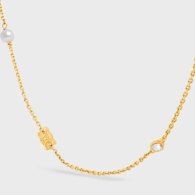 Les Perles CELINE Halskette aus Strass, Kunstharzperlen und Messing mit Goldfinish Les Perles CELINE Halskette aus Strass, Kunstharzperlen und Messing mit Goldfinish