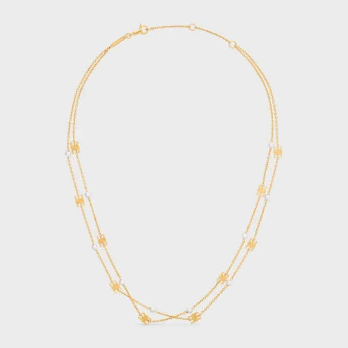 Triomphe Pearl Doppelkette aus Messing mit Goldfinish und Kunstharzperlen Triomphe Pearl Doppelkette aus Messing mit Goldfinish und Kunstharzperlen